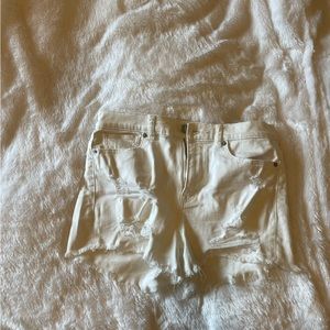 Distressed white jean shorts
